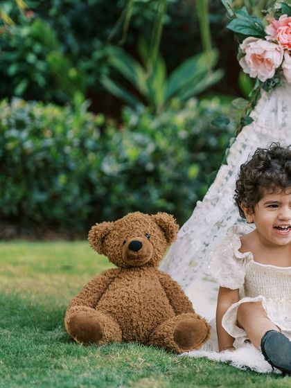 A little girl and her teddy bear in a teepee. A perfect setup for a whimsical birthday shoot.