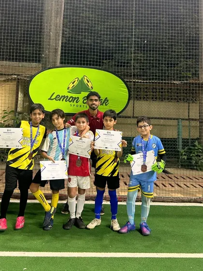 Our U-9 team proudly showing off their medals and certificates after participating in a local league. We believe in celebrating participation and the courage to compete.