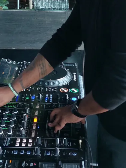 A close up showing my hands working the mixer. My experience allows me to manipulate the sound in real time, adding effects and layers to make each set unique.
