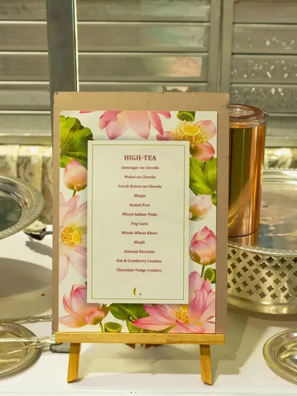 A beautifully designed high-tea menu, detailing our selection of traditional Indian snacks like Dhokla, Khandvi, and Samosa, alongside sweet treats.