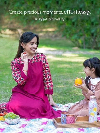 A picnic scene created for a Children's Day campaign with 'Ek By Ekta'. The styling is soft and natural, focusing on creating a precious moment between mother and child.