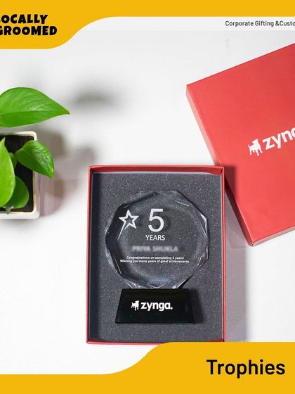 A close-up of the 5-year anniversary crystal trophy for Zynga, presented in its custom red box. This is a perfect example of a premium recognition gift.