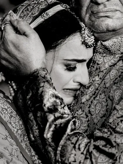 The vidaai, or farewell. A daughter's emotional embrace with her father is one of the most powerful moments of a wedding day. I capture these raw, heartfelt goodbyes with sensitivity.