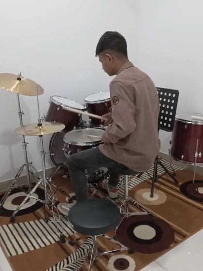 Another angle of our student on the drums, working on his rhythm and coordination.