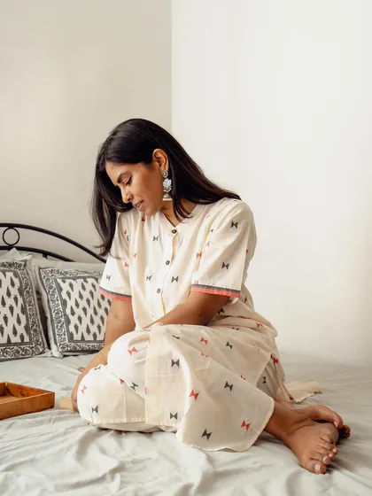 A gentle, downward-looking pose that conveys a sense of calm and comfort. This image helps tell the story of the clothing being perfect for relaxed moments at home.