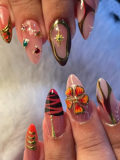 A different perspective on our multi-design nail set. This angle shows the beautiful contrast between the bold patterns and the delicate, sparkling gemstone details.