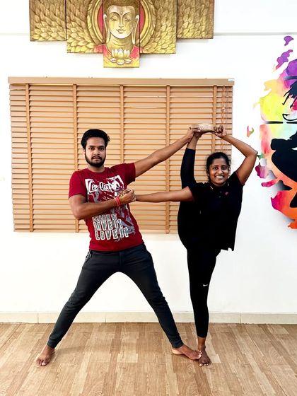 Another example of a partner-assisted standing split. This collaborative approach builds trust and helps students achieve poses they might not be able to on their own.