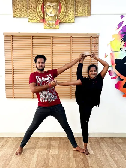 Another example of a partner-assisted standing split. This collaborative approach builds trust and helps students achieve poses they might not be able to on their own.
