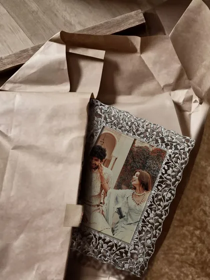 Wrap a memory, gift a bond. My engraved silver frame, with its intricate cutwork, makes the perfect keepsake for a loved one, turning a photo into a piece of art.