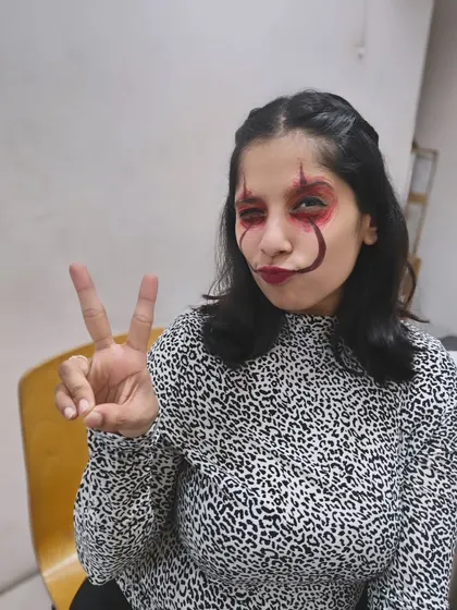 Peace, love, and spooky vibes. A student shows off her creepy face paint during a break from dancing at our Halloween party.