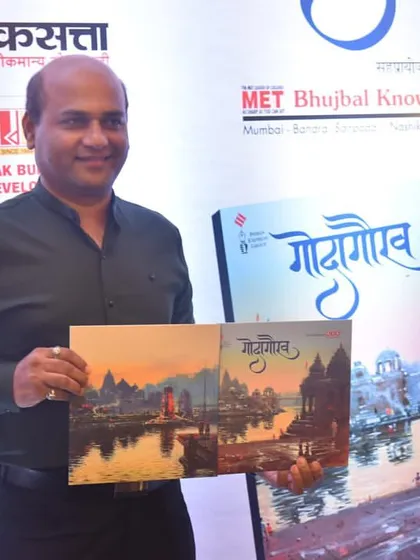 Holding the "Godagaurav" book, showing both my paintings used for the front and back covers. A moment of immense pride.