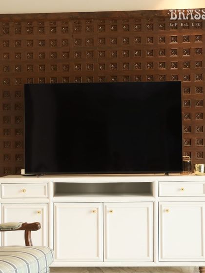 Our Sphere knobs on a white media console, set against a traditional carved wood panel. This shows how simple, classic hardware can bridge modern furniture and heritage decor.