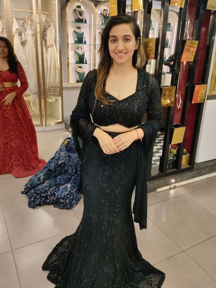 A happy client looking chic and stylish in a black sequin fish-cut gown. It's a timeless choice for any cocktail party or formal event.