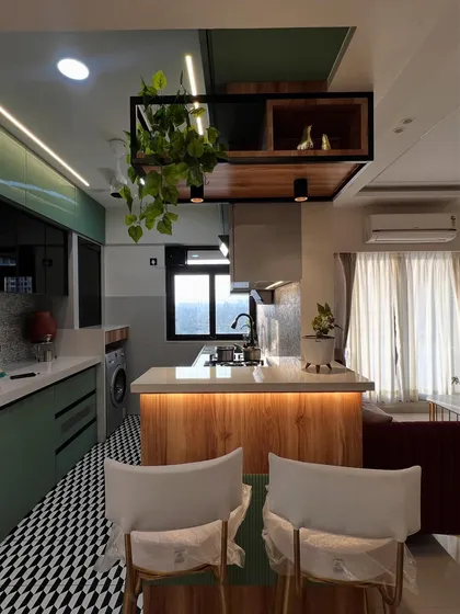 This angle highlights the under-cabinet lighting and the functional layout of the kitchen island.
