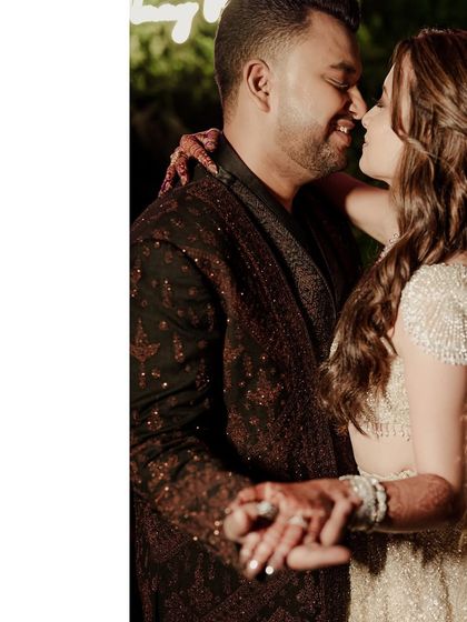 An intimate moment on the dance floor. This close-up captures the couple's connection and gives a glimpse of the bride's sparkling blouse and the groom's intricately woven jacket.