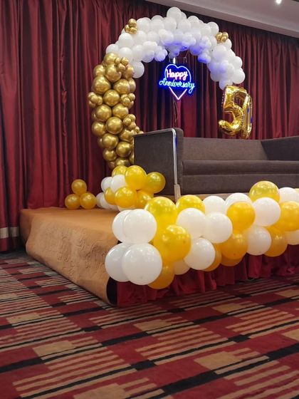 This view shows the complete stage setup with the sofa for the couple. The decor is designed to be a beautiful background for photos and the cake-cutting ceremony.