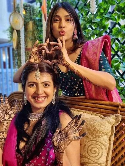 Friends celebrating together, showing off their beautiful mehndi designs. We love doing mehndi for the entire bridal party.