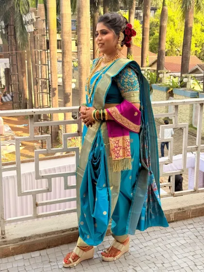 A full-length view of the bride in her stylishly draped nauvari saree, ready for her wedding rituals.