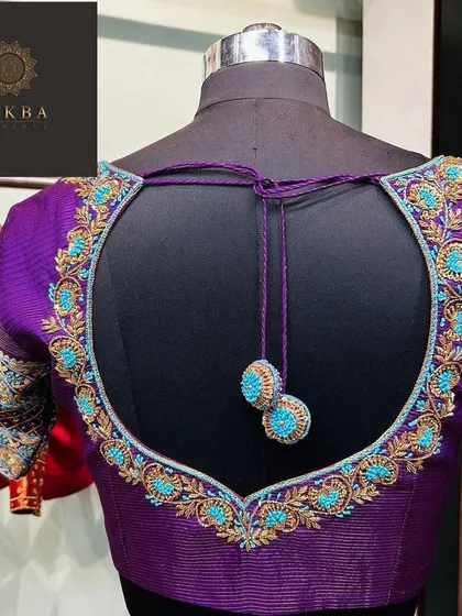 I love creating designs that are both elegant and playful, like this deep purple blouse. The heart-shaped cutout on the back is highlighted with contrasting turquoise and gold embroidery, finished with delicate, handcrafted tassels that add a touch of movement.