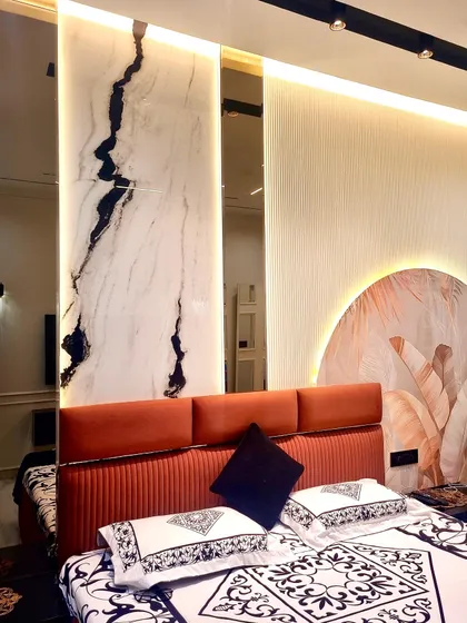 A detail shot of the stunning headboard wall, featuring a mix of fluted panels, a custom art mural, and a dramatic marble-finish panel with integrated mirror accents.