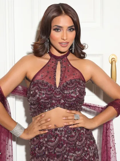 A powerful and confident stance. The makeup is bold and defined, matching her strong and beautiful presence.