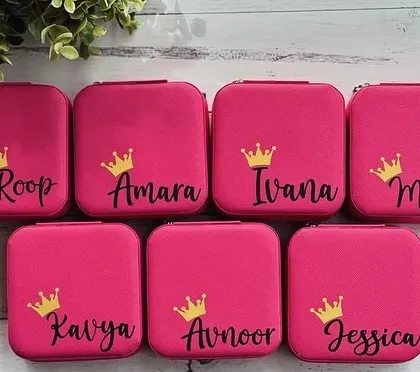 A set of bright pink jewellery organizers, personalised with names and a cute crown detail. These make for fantastic and practical return gifts for a girl's birthday party or a bridal shower.