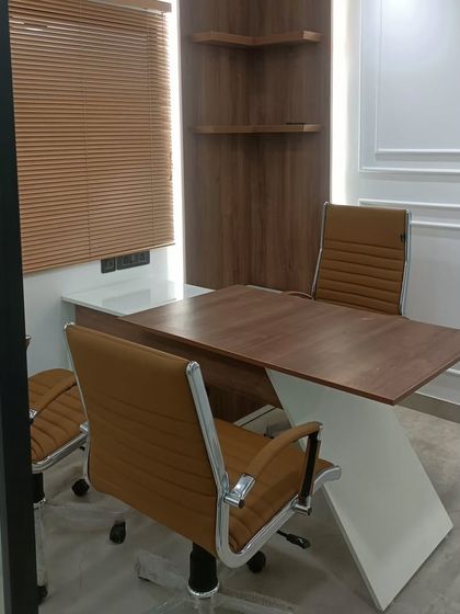 A private cabin in the recently handed-over CA office. The design combines a sleek, modern desk with classic wood tones and neo-classical wall molding for a timeless and professional look.
