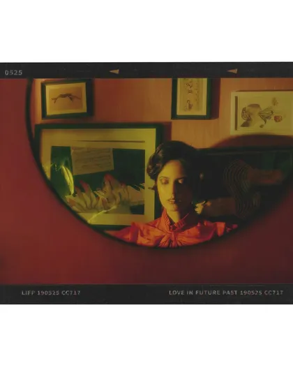 Another cinematic still from the 'Gallery of Expectations'. The composition uses a round mirror to frame the subject, creating a voyeuristic and intimate perspective.