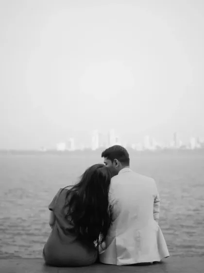 A timeless black and white shot, capturing a moment of peace and togetherness with the city skyline in the distance.