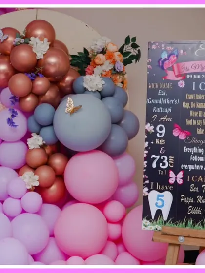 A personalized milestone board for a butterfly-themed first birthday, detailing the baby's achievements and favorites.