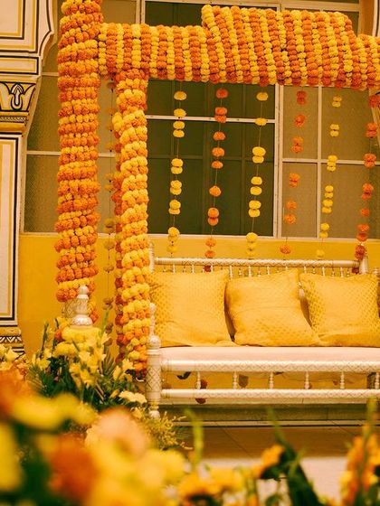 Marigolds, or 'genda phool', are a timeless part of Indian festivities. For this Haldi, we created a beautiful jhoola (swing) for the bride, completely covered in marigolds, evoking a sense of nostalgia and old-school charm.