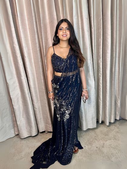 A full-length view of this redefined glamour. The makeup is understated yet elegant, letting the stunning outfit shine.