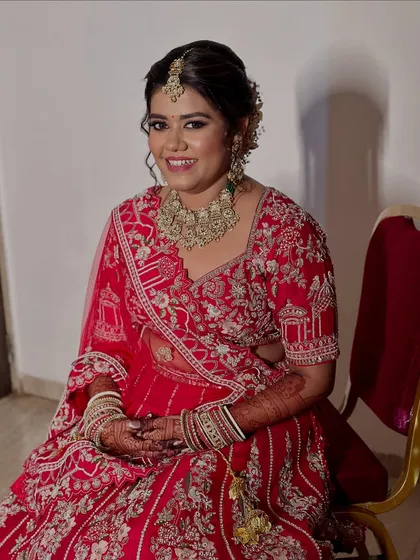A regal bride in red. We created a look with bold, soft kohl-rimmed eyes and lashes that cast a spell of elegance.