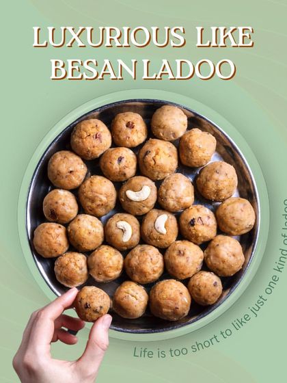 Our Besan Ladoos are pure luxury. We roast the gram flour in desi ghee until it's fragrant and golden, then mix it with sugar and nuts. A hand is shown picking one up, showing how irresistible they are.