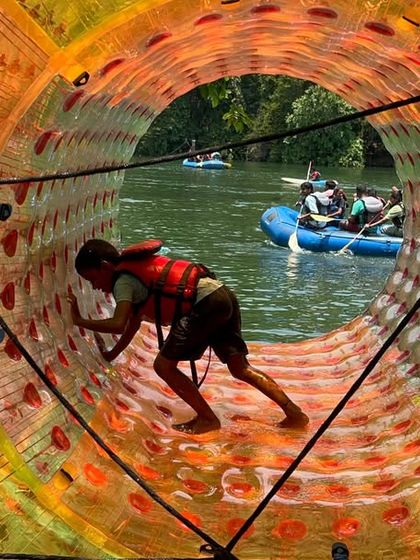 A participant tries out water zorbing, one of the fun aqua activities we offer alongside rafting and kayaking at our Dandeli camp.