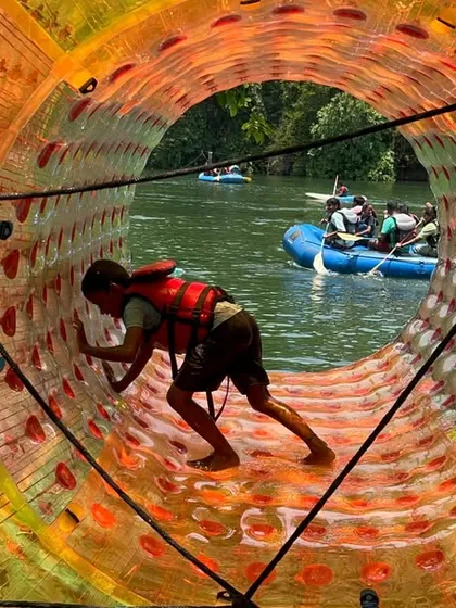 Fun on the water takes many forms. Here, a participant tries his hand at water rolling, a fun and challenging activity at our Dandeli camp.