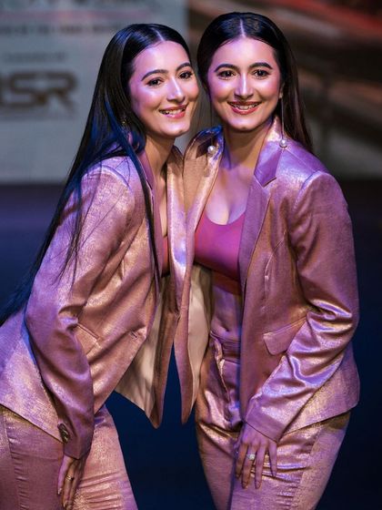 A shot of the Shetty twins walking the ramp in matching metallic suits for a designer at Bangalore Times Fashion Week. Capturing multiple models in a single frame requires precise timing and composition.
