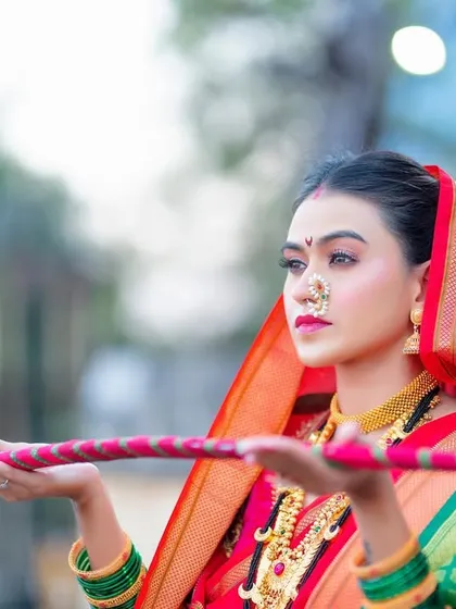 A creative shot from the 'Shivkanya' series, with the model holding a traditional 'talwar' or sword.