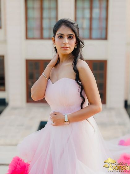 A stunning close-up portrait of the bride, highlighting her elegant hair, makeup, and the delicate design of her gown.