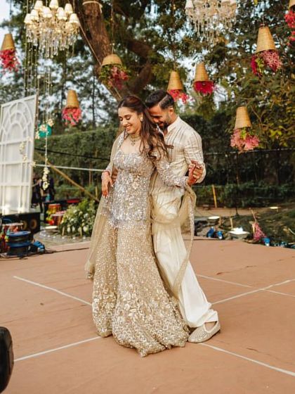 The beauty of a candid dance moment. This shot captures the pure happiness between the couple during their outdoor sangeet performance, a memory they will cherish forever.