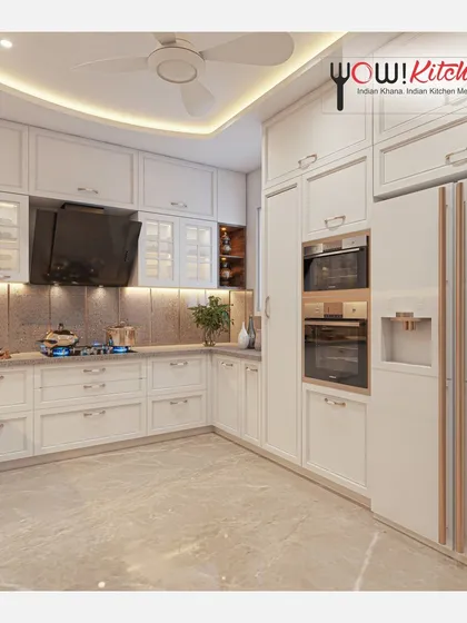 A look at a timeless all-white U-shaped kitchen. This design maximizes space with floor-to-ceiling cabinetry, integrated double ovens, and a dedicated space for a side-by-side refrigerator, creating a bright and highly functional cooking environment.