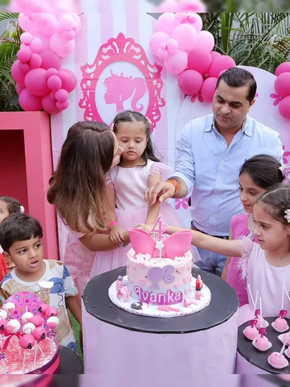 Capturing the special moment of the cake cutting at a Barbie-themed party. We coordinate everything, so families can focus on making memories.