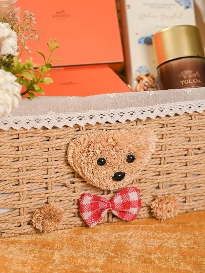 It's the little details that make a gift special. This close-up shows the adorable teddy bear with a gingham bow that I added to the front of the wicker basket for a sweet, handcrafted touch.