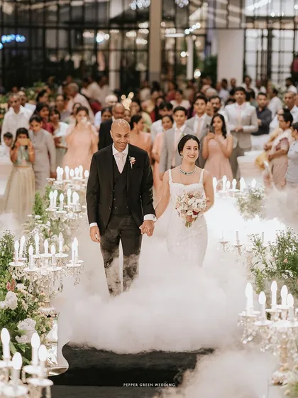 A truly magical entrance into the reception, as the couple walks through a cloud of low fog, surrounded by candlelight. This is how fairytales are brought to life.
