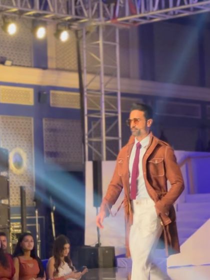 On the runway, our brown belted long coat makes a statement. This is a versatile piece of outerwear, perfect for the fashion-conscious gentleman.