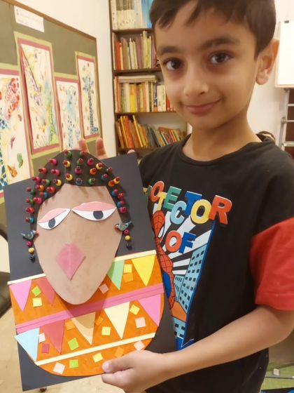 As part of our "Project Africa," students create mixed-media portraits inspired by tribal art. This piece uses paper collage and beads to create a wonderfully textured and colorful result.