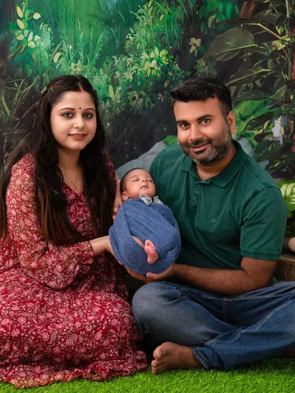 A newborn's jungle adventure. This creative setup places the swaddled baby in a lush, green jungle theme, showcasing our ability to bring imaginative ideas to life.