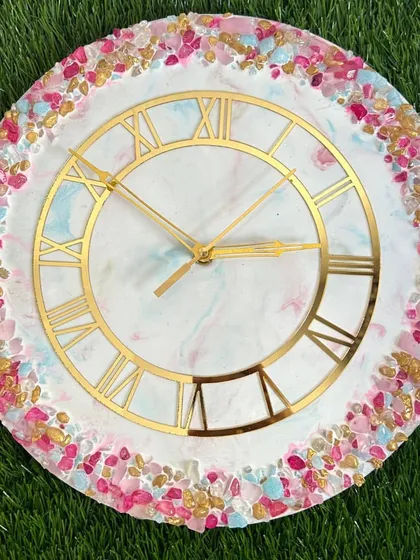 A playful and colorful resin clock with a border of pink, blue, and gold crystals. This shows how you can customize colors to create something truly unique.