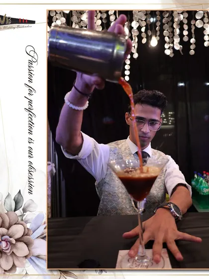 An expertly crafted Espresso Martini being poured, showing the rich crema on top which is a sign of a well-made cocktail.