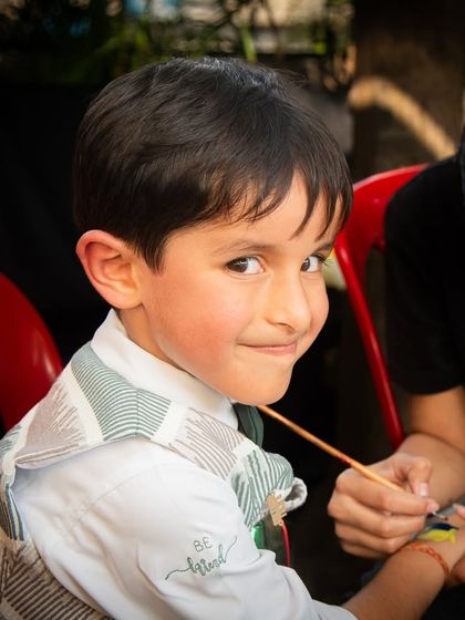 A cheeky smile from one of the party guests while getting a temporary tattoo. I focus on capturing the fun experiences of everyone at the event.
